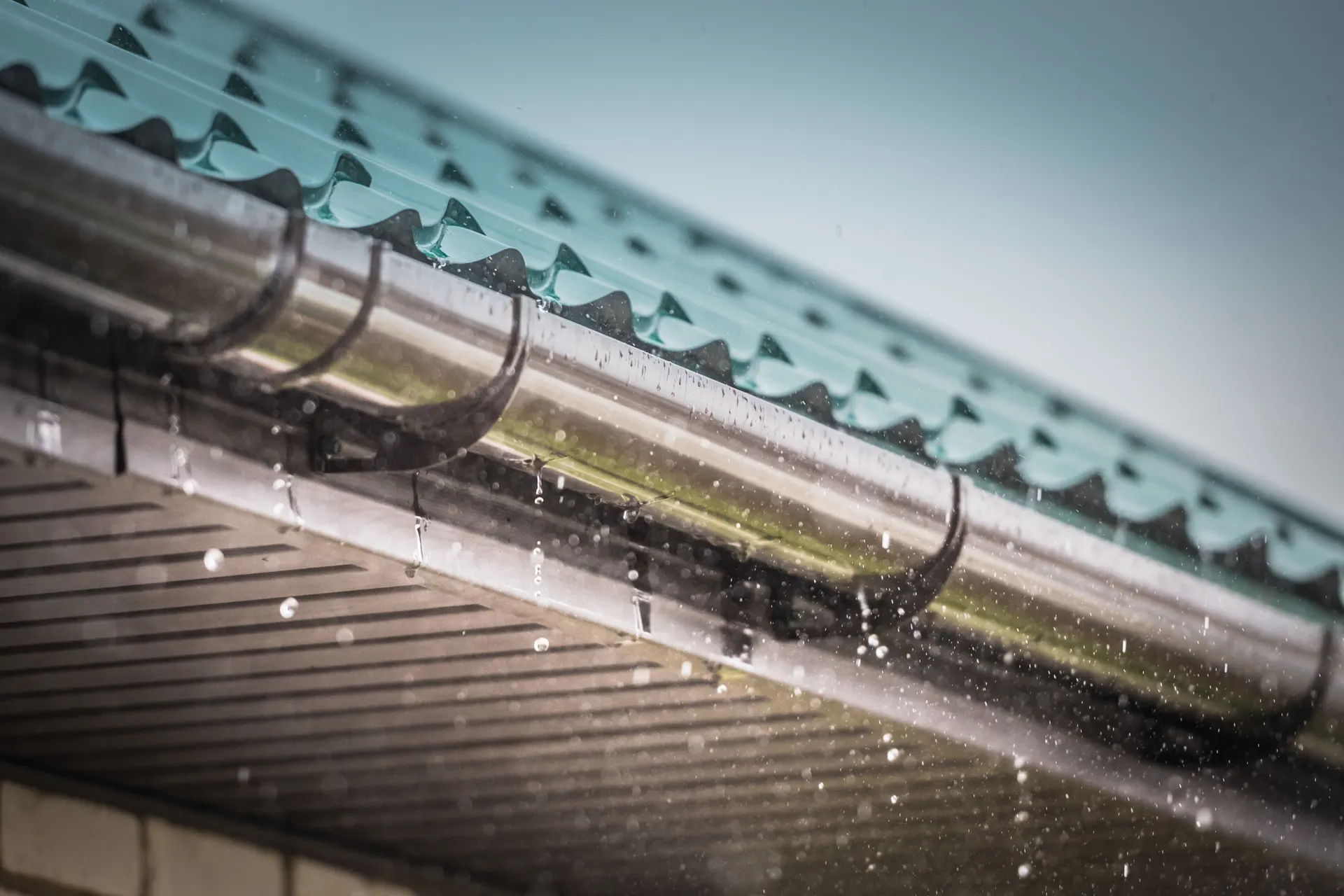 Rain flowing from a roof gutter